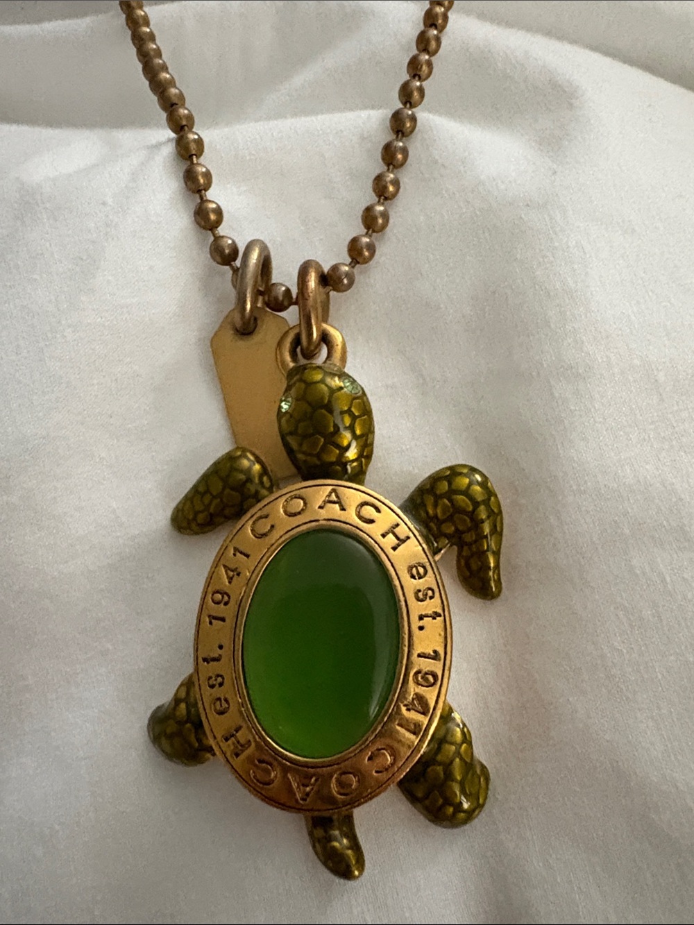 Coach Gold-Tone Turtle Necklace with Green Enamel Center - Picture 2 of 2